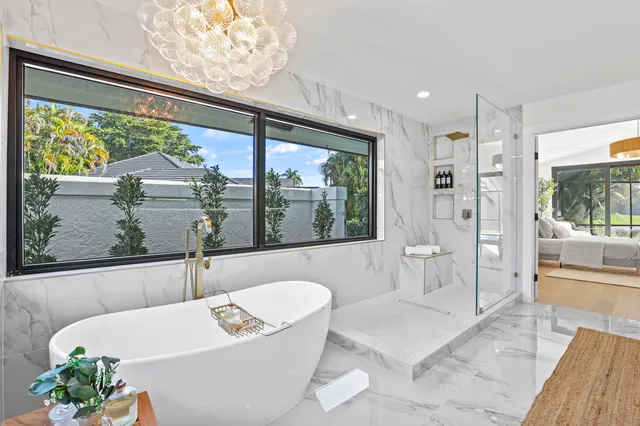 an aerial view of a house with swimming pool and lake view