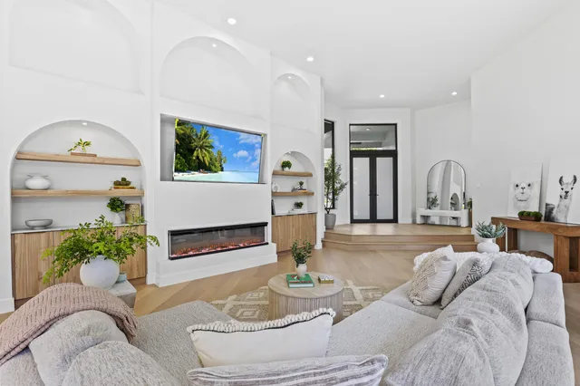 a living room with furniture and large windows