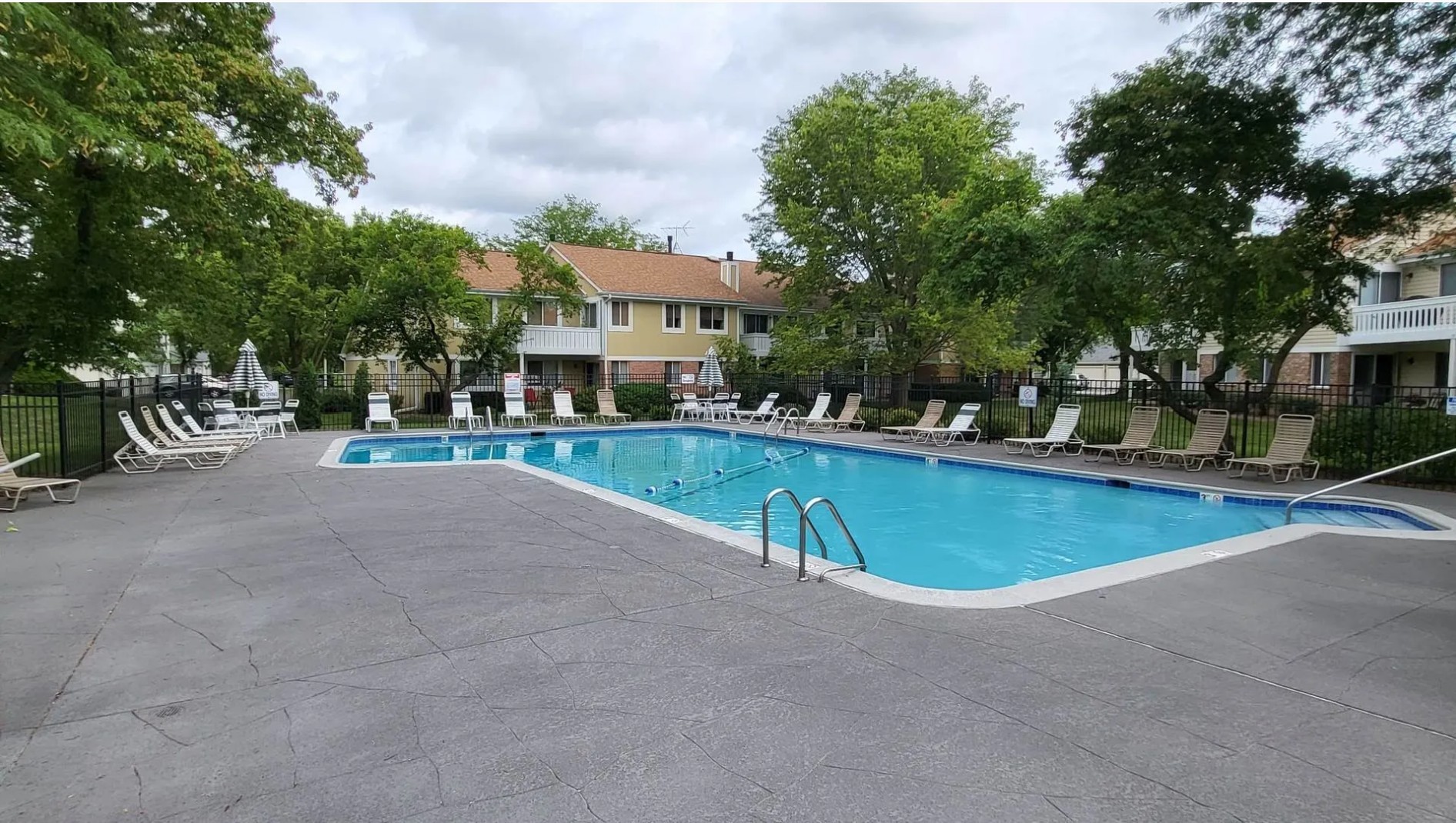 1186 Auburn Lane, Unit 1186 Buffalo Grove, IL 60089 - Photo 20 of 23 a view of a swimming pool with lawn chairs and plants