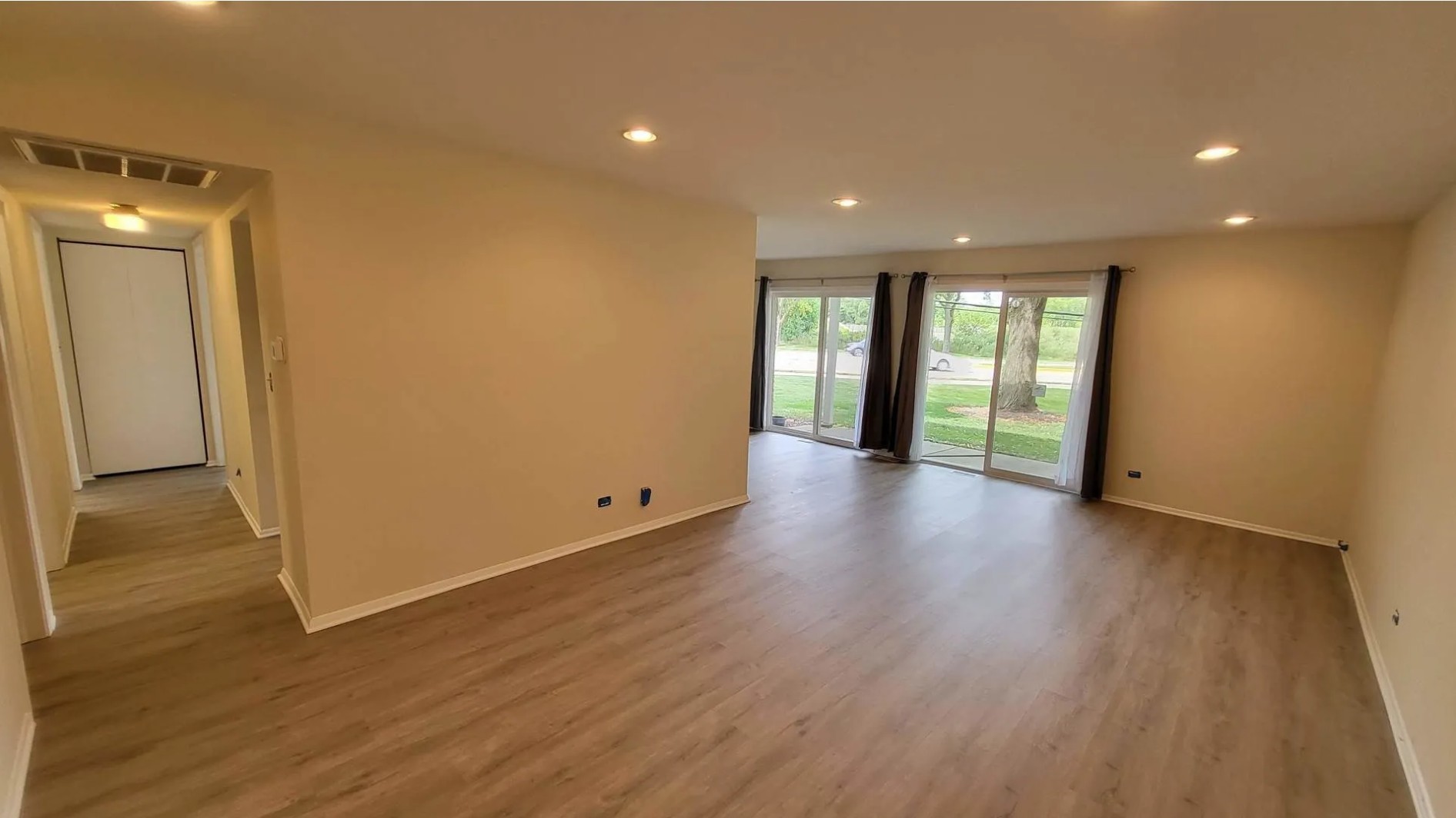 1186 Auburn Lane, Unit 1186 Buffalo Grove, IL 60089 - Photo 2 of 23 a view of an empty room with wooden floor and a window