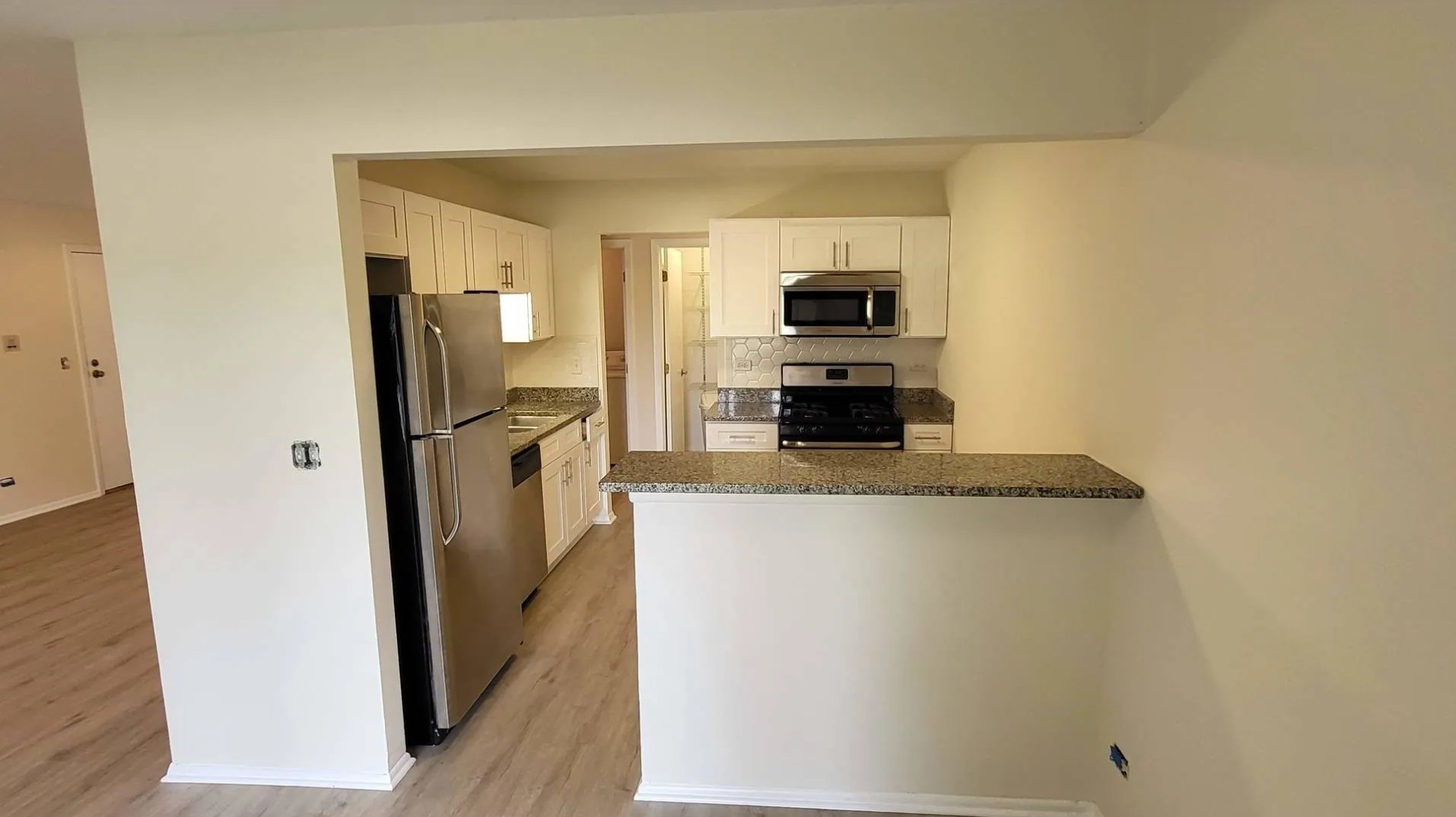 1186 Auburn Lane, Unit 1186 Buffalo Grove, IL 60089 - Photo 6 of 23 a kitchen with stainless steel appliances a refrigerator stove microwave and sink