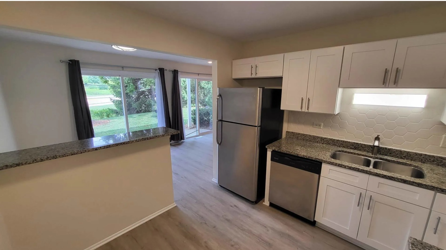 1186 Auburn Lane, Unit 1186 Buffalo Grove, IL 60089 - Photo 7 of 23 a kitchen with a refrigerator a stove a sink and a window
