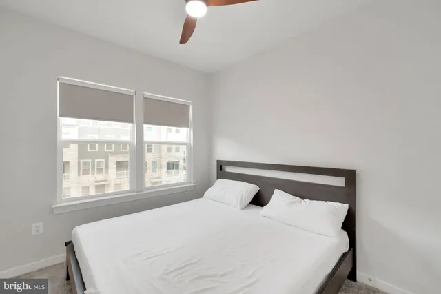 a bedroom with a large bed and a large window