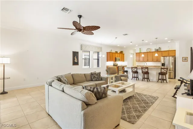 a living room with furniture and kitchen view