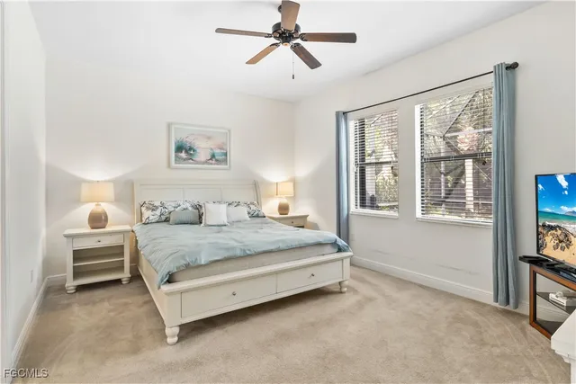 a spacious bedroom with a bed a dresser and next to a window