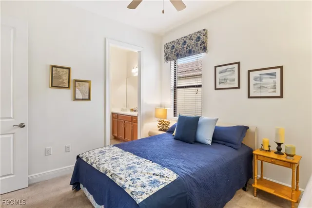 a bedroom with a bed and painting on the wall