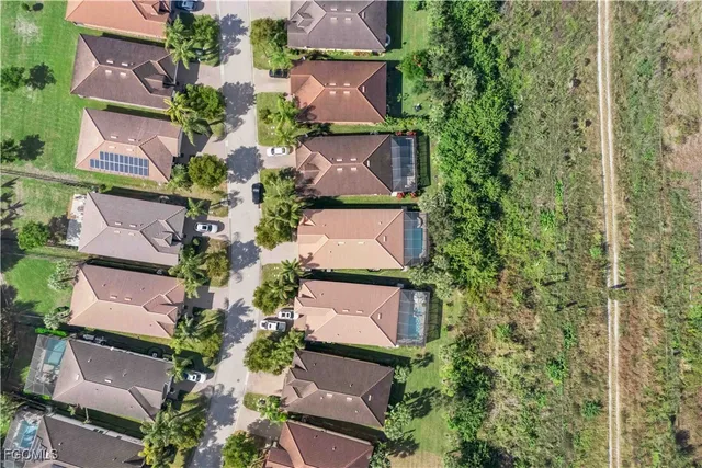 an aerial view of residential houses with outdoor space