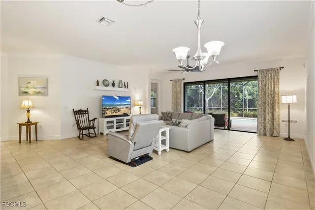 a living room with fireplace furniture and a chandelier