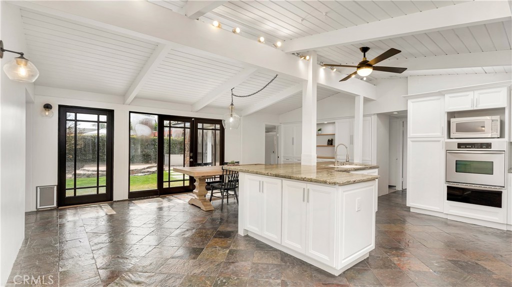 Natural Slate Floors throughout Open-Formatted Island-Style Kitchen & Dining Area (complete with pet door)