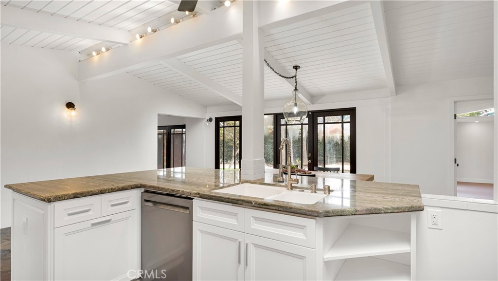 3317 Lees Avenue Long Beach, CA 90808 - Photo 14 of 75 View from Cooktop, across the expansive granite/stone island with sink and dishwasher out through the courtyard doors/windows and dining area.