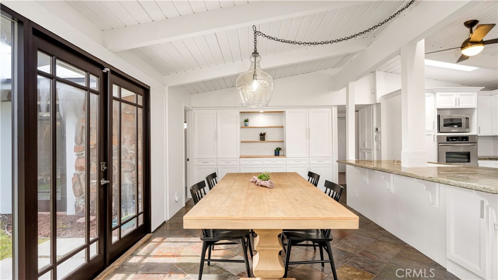 3317 Lees Avenue Long Beach, CA 90808 - Photo 15 of 75 Sizable Dining Area sits on the beautiful sealed slate floors with immediate French Door access to the courtyard, island counter seating area and new wall of massive pantry storage and prep area adorned in new Butcher Block Counter.