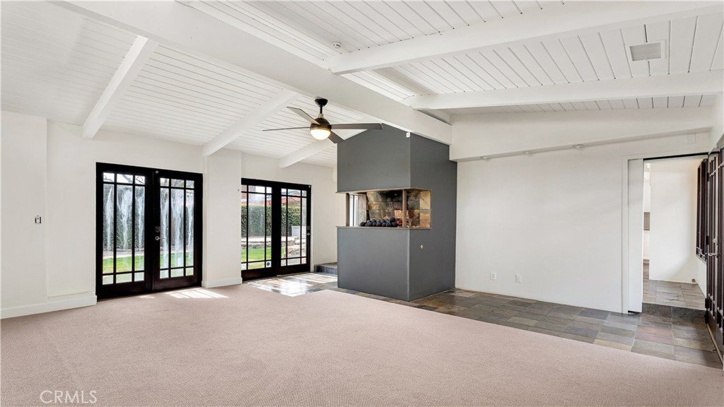 3317 Lees Avenue Long Beach, CA 90808 - Photo 23 of 75 View from the Family/Living Room toward the Courtyard Doors and fireplace. Slate walkway leads into open island-style kitchen and dining area. (new carpet throughout)