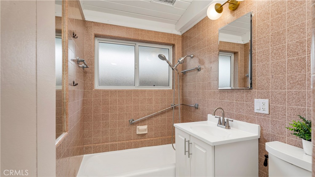 3317 Lees Avenue Long Beach, CA 90808 - Photo 29 of 75 Hall/Guest Full Bath with new faucets, new privacy window, new fixtures, new vanity and toilet and new medicine cabinet and mid-century lighting - complete with remotely located humidity-controlled exhaust vent fan too.