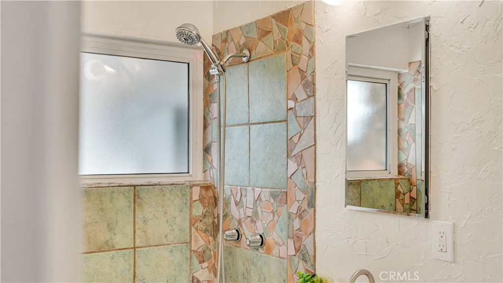 3317 Lees Avenue Long Beach, CA 90808 - Photo 41 of 75 Artfully decorated Primary enSuite Bath complete with shower, new vanity, new toilet, new dual medicine cabinets, new faucets and fixtures and new mid-century lighting
