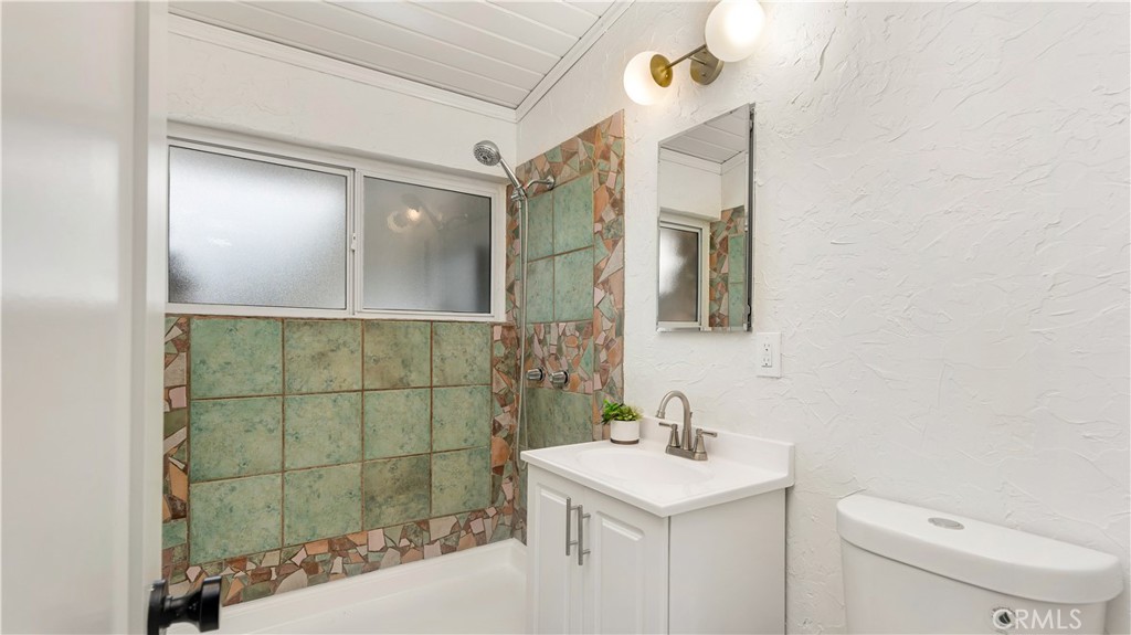 3317 Lees Avenue Long Beach, CA 90808 - Photo 42 of 75 Artfully decorated Primary enSuite Bath complete with shower, new vanity, new toilet, new dual medicine cabinets, new faucets and fixtures and new mid-century lighting