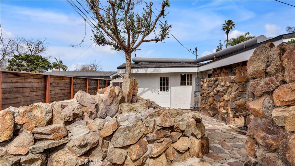 3317 Lees Avenue Long Beach, CA 90808 - Photo 47 of 75 Rear western back of the lot with rock structures that help support and protect the underground bunker/shelter below.
