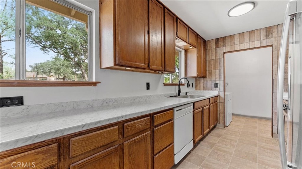 112 Los Verjeles Road Bangor, CA 95901 - Photo 21 of 48 a kitchen with stainless steel appliances granite countertop a sink and a refrigerator