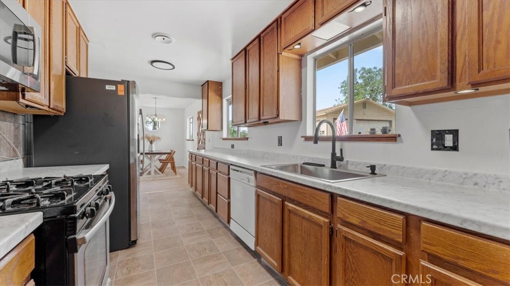 112 Los Verjeles Road Bangor, CA 95901 - Photo 23 of 48 a kitchen with stainless steel appliances granite countertop a sink stove and refrigerator