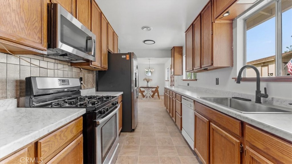 112 Los Verjeles Road Bangor, CA 95901 - Photo 25 of 48 a kitchen with stainless steel appliances granite countertop a sink stove and cabinets