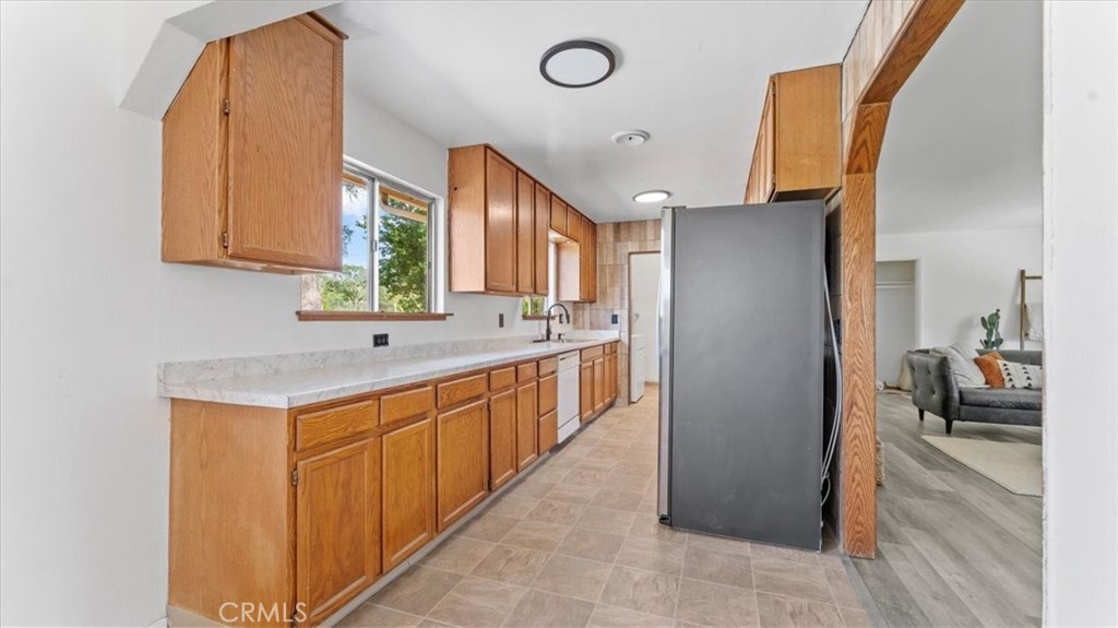 112 Los Verjeles Road Bangor, CA 95901 - Photo 26 of 48 a kitchen with stainless steel appliances granite countertop a sink and a refrigerator