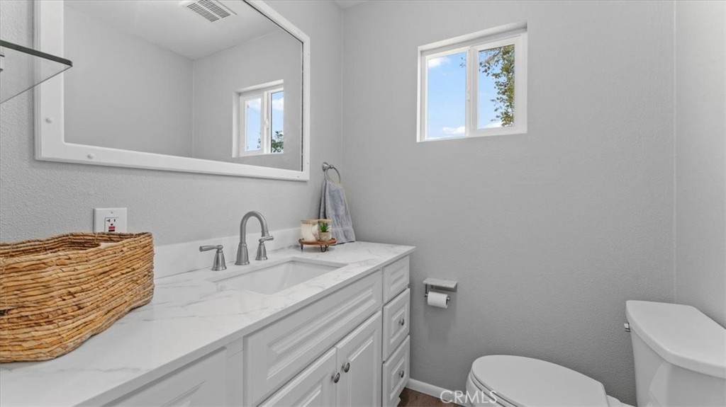 112 Los Verjeles Road Bangor, CA 95901 - Photo 34 of 48 a bathroom with a granite countertop toilet sink and mirror