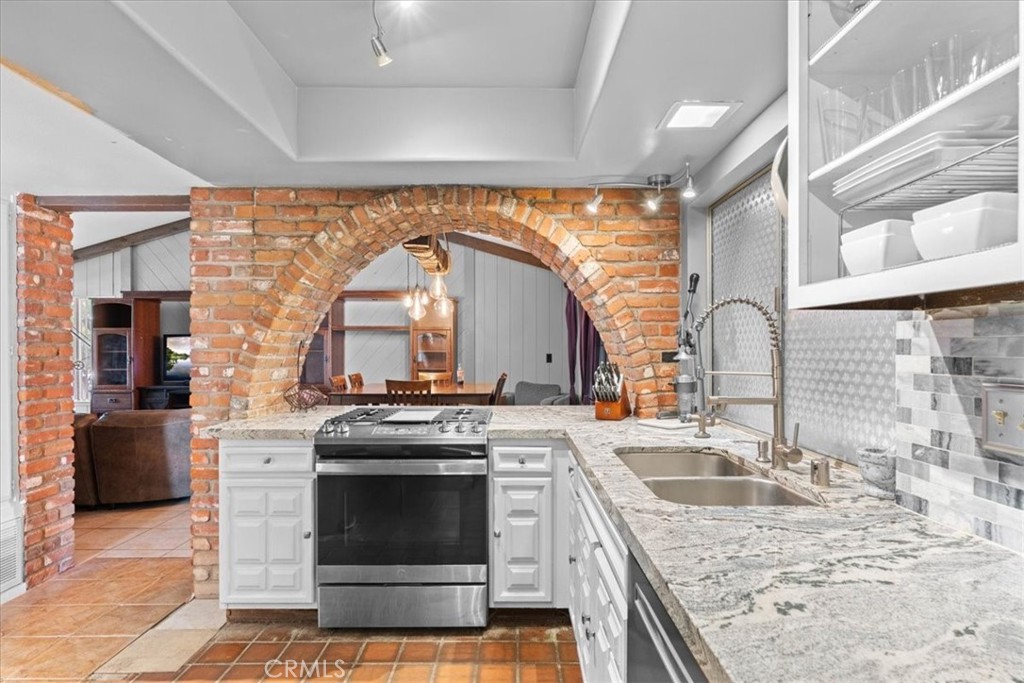 222 Village Square Fillmore, CA 93015 - Photo 13 of 39 a kitchen with a stove top oven and sink