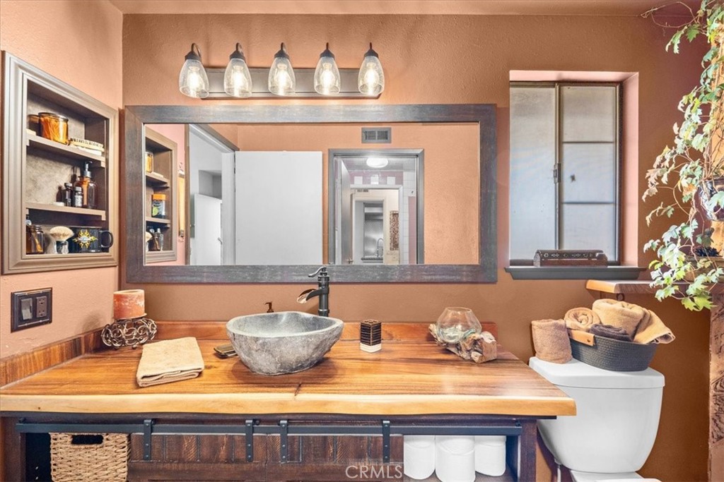 222 Village Square Fillmore, CA 93015 - Photo 19 of 39 a bathroom with a granite countertop sink and a mirror