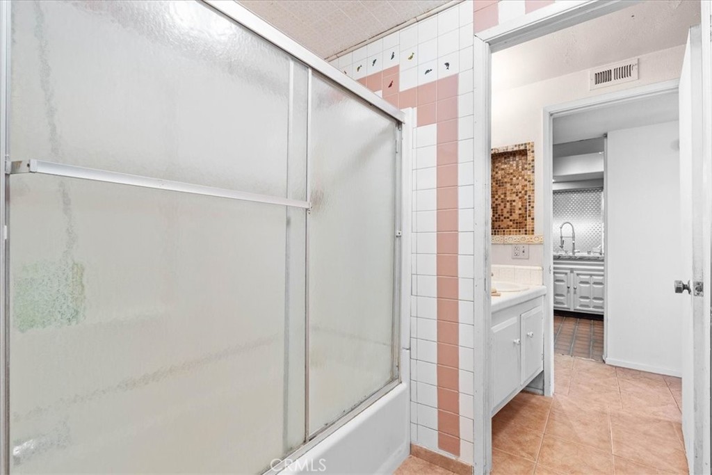 222 Village Square Fillmore, CA 93015 - Photo 21 of 39 a bathroom with a shower and a glass door