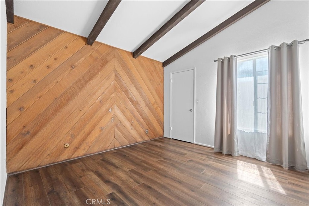 222 Village Square Fillmore, CA 93015 - Photo 22 of 39 a view of an empty room with wooden floor and a window