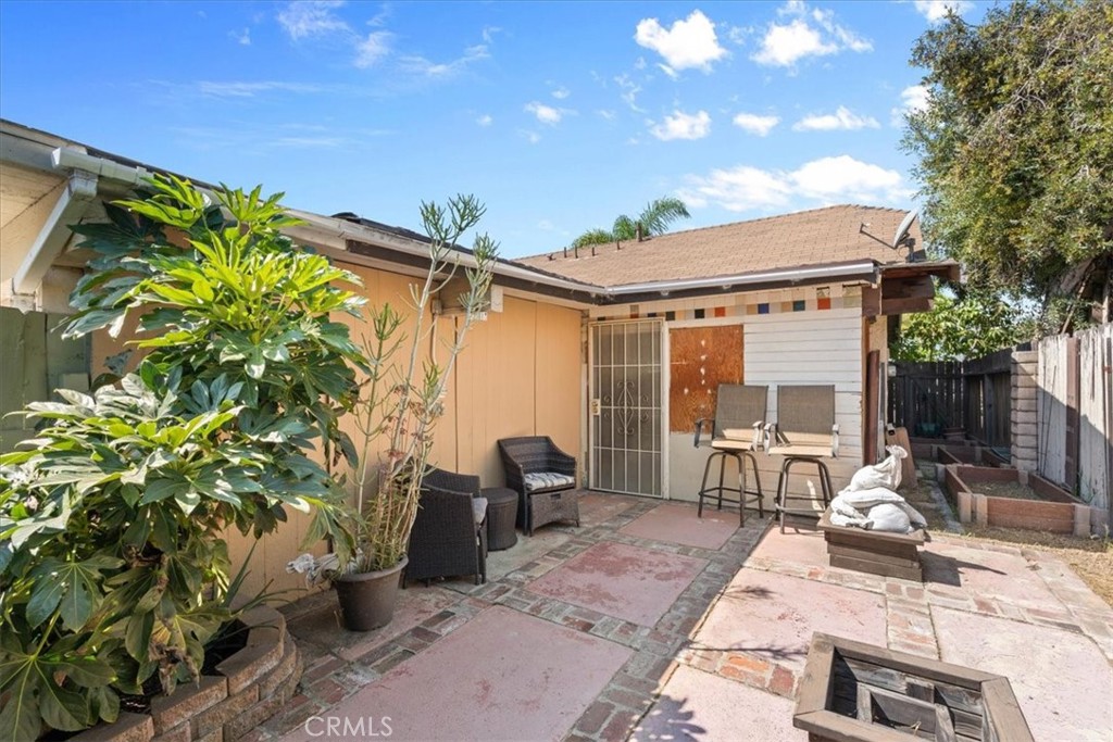 222 Village Square Fillmore, CA 93015 - Photo 28 of 39 a view of a patio with table and chairs and potted plants