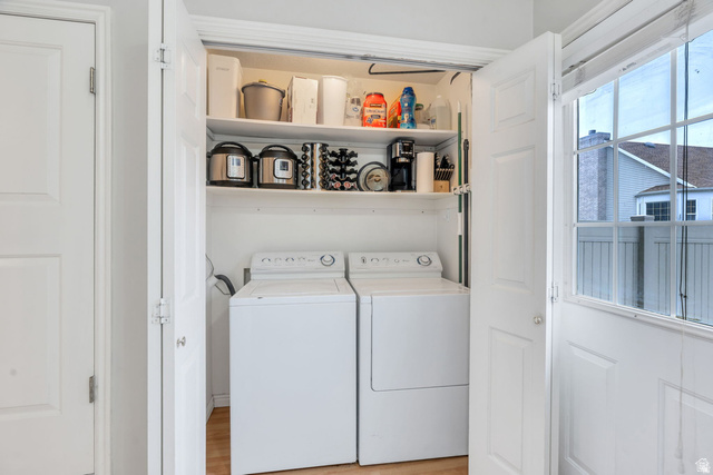 986 Independence Avenue Provo, UT 84604 - Photo 11 of 29 Dedicated laundry closet featuring integrated shelving, and wood-finish flooring