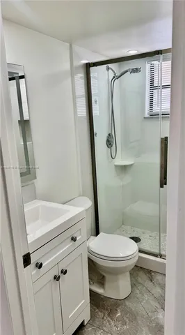 a white toilet sitting next to a bathroom sink
