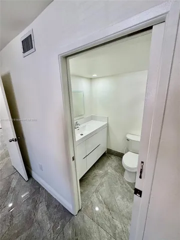 a bathroom with a sink a toilet and a shower
