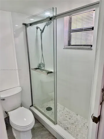 a bathroom with a shower and a toilet