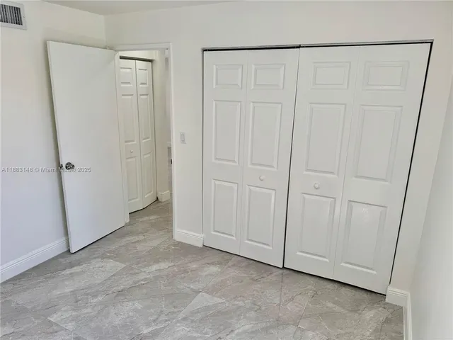 an empty room with a wooden door