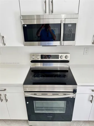 a stove top oven sitting inside of a kitchen