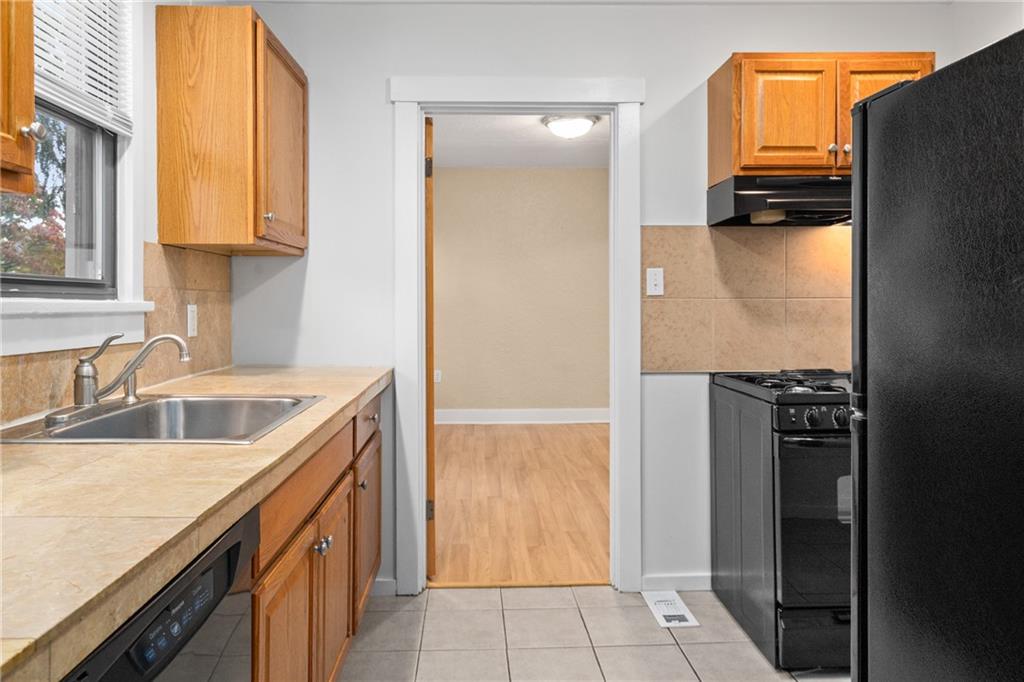 3612 Main Street Homestead, PA 15120 - Photo 14 of 33 a kitchen with a refrigerator and a sink