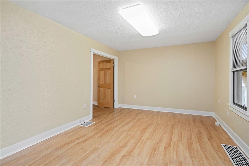 3612 Main Street Homestead, PA 15120 - Photo 8 of 33 an empty room with wooden floor and windows