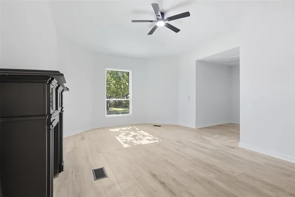 a spacious bedroom with a bed a couch and a window