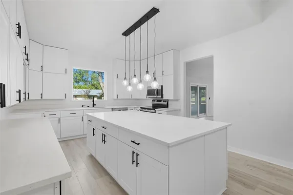 a kitchen with cabinets a sink and appliances