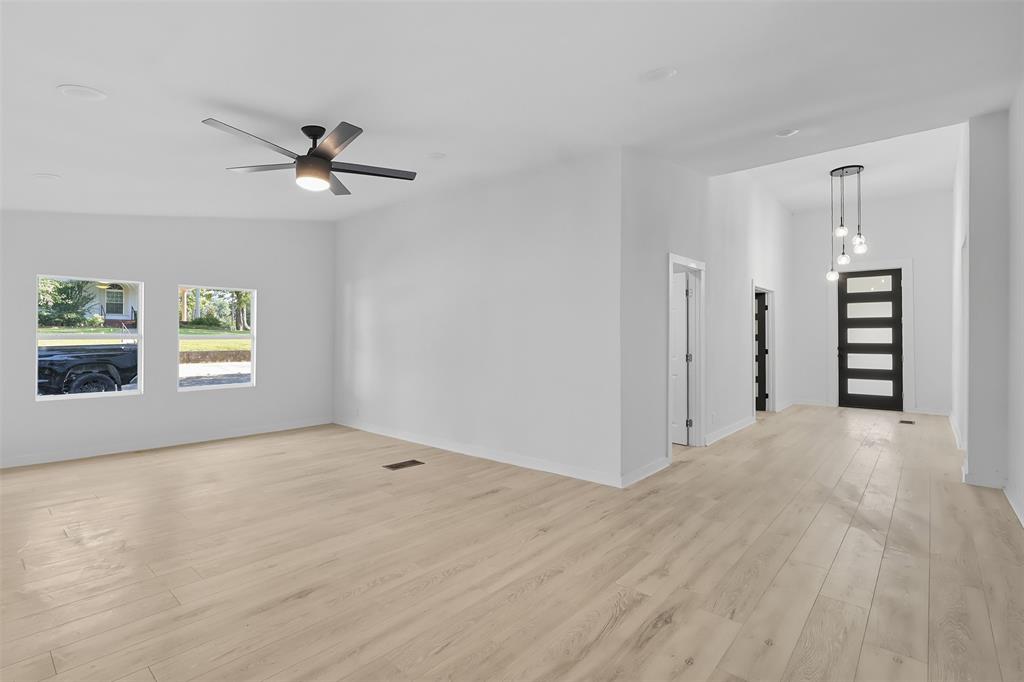 605 North Main Street Winnsboro, TX 75494 - Photo 20 of 29 a view of empty room with wooden floor and window