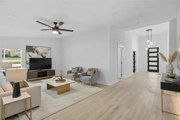 a view of empty room with wooden floor and window