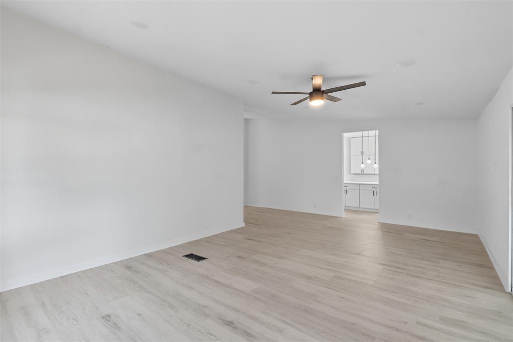 605 North Main Street Winnsboro, TX 75494 - Photo 21 of 29 wooden floor in an empty room with a window