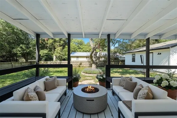 a view of chairs in balcony with wooden floor