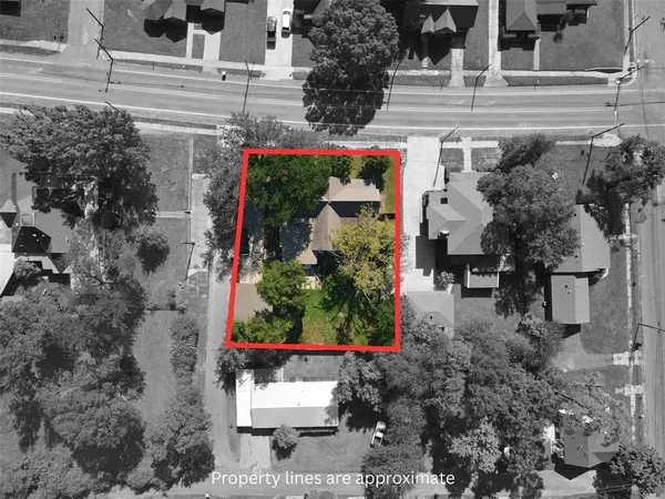 an aerial view of residential houses with outdoor space and trees