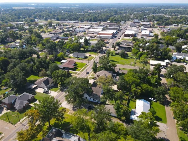 an aerial view of a house with a yard garden and swimming pool