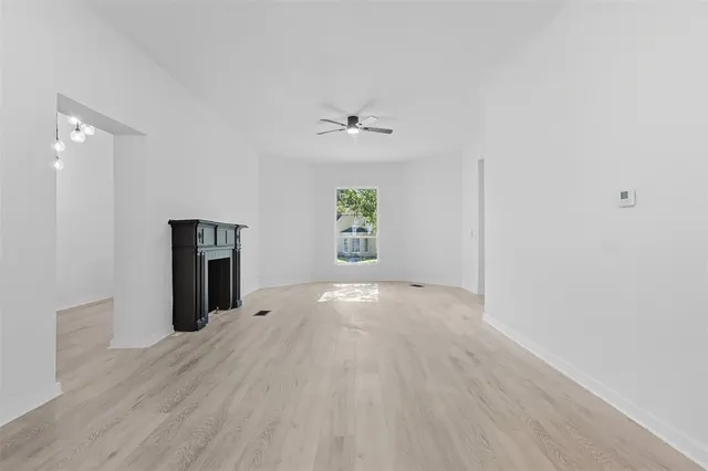 wooden floor in an empty room with a window