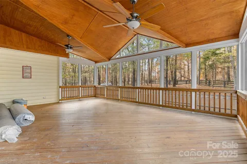 a view of a porch with wooden floor and roof