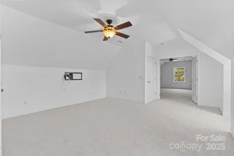 an empty room with closet and windows