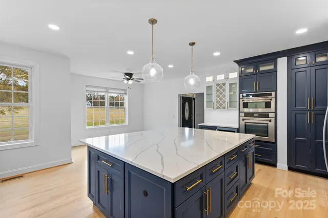a kitchen with a refrigerator a sink and a oven